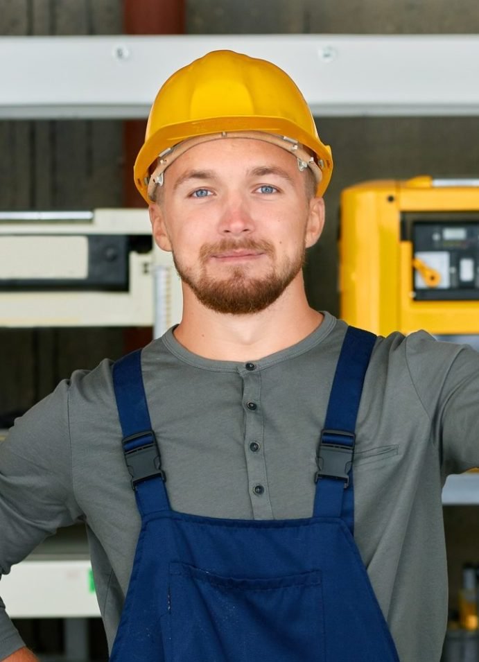 young workman posing at factory e1638170101501
